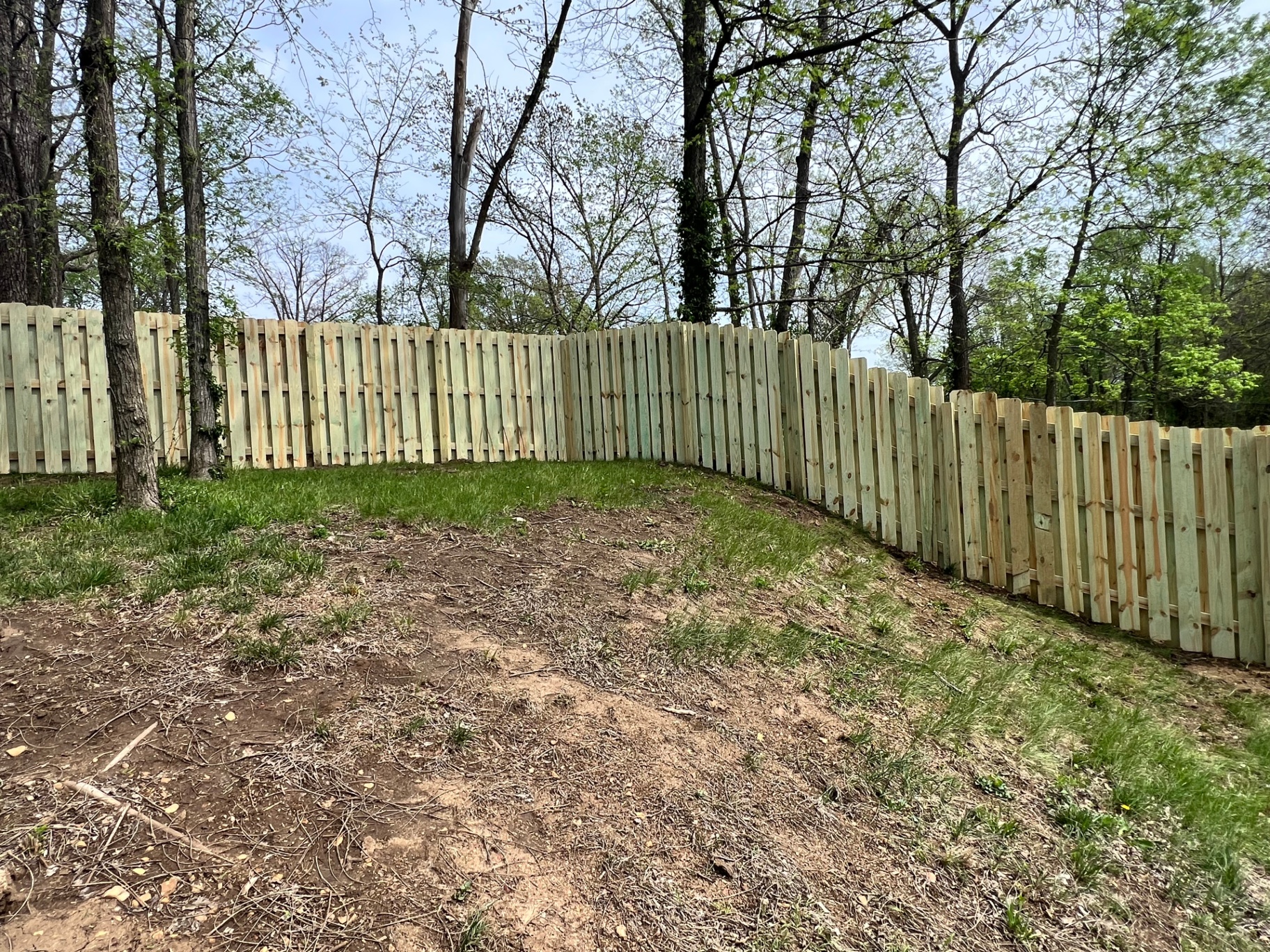 6 ft pressure treated pine shadowbox fence stepping across a wooded hillside in Shawnee, KS 6 ft pressure treated pine shadowbox fence stepping across a wooded hillside in Shawnee, KS