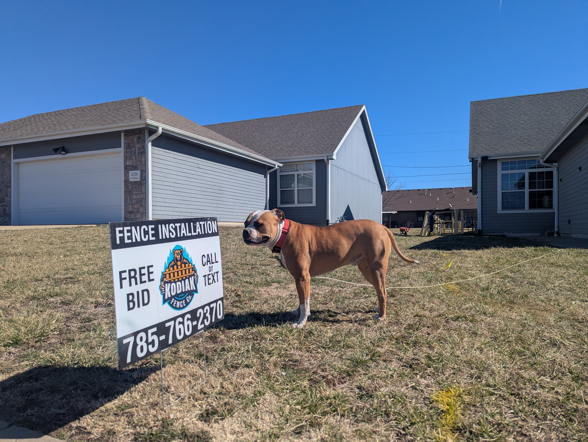 Kodiak Fence Company yard sign with bulldog on a Kansas City job site — Free Bid, Call or Text 785-766-2370
