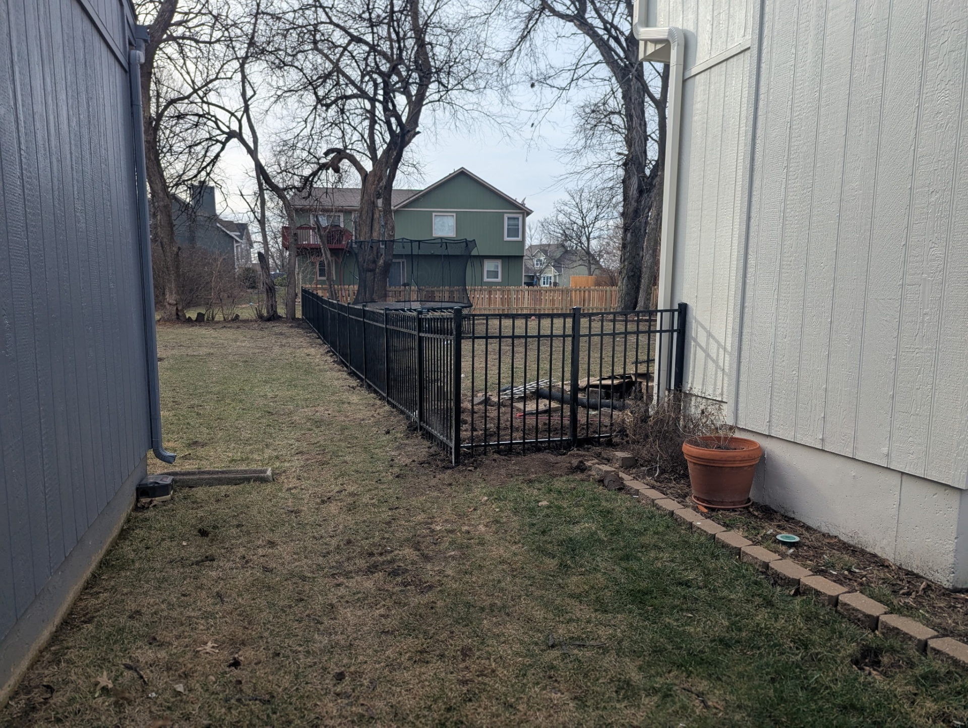 Side yard run of 4 ft flat-top black ornamental aluminum fence — Overland Park, KS