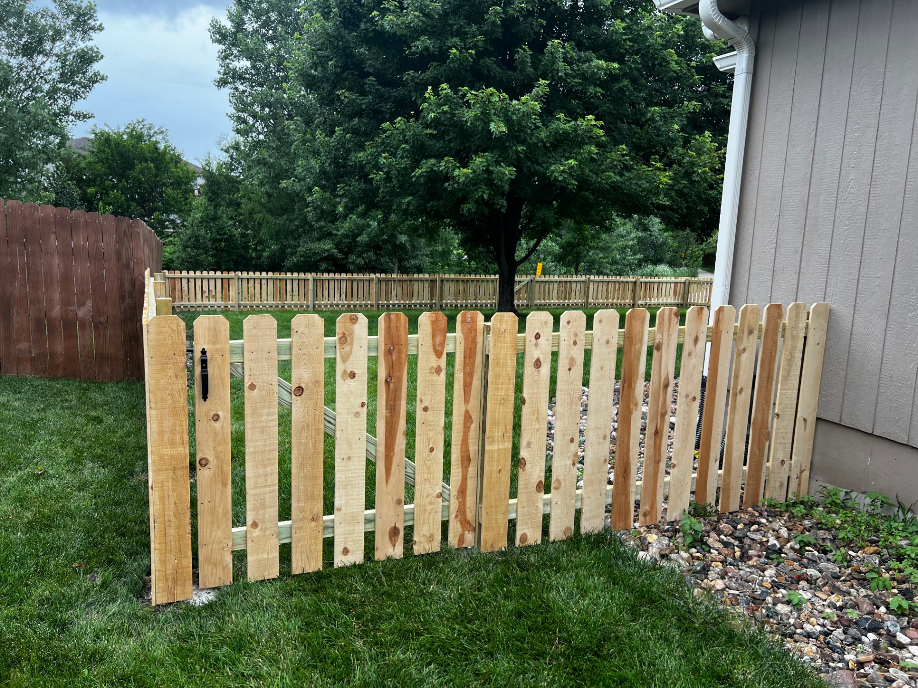 4' spaced cedar dog ear picket fence with gate along side yard — Gardner, KS