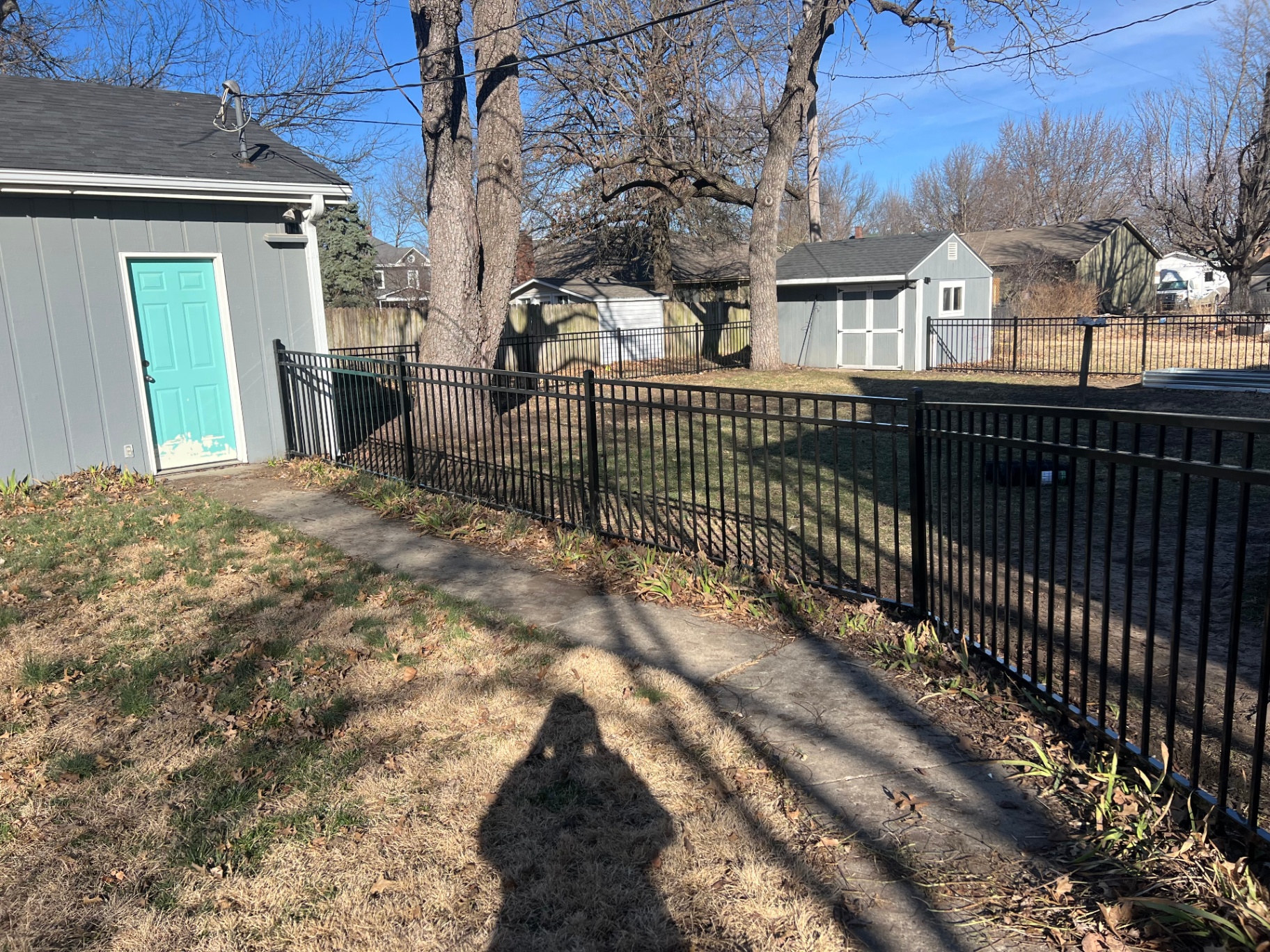 4 ft flat-top black aluminum fence running along a sidewalk on a corner lot — Overland Park, KS